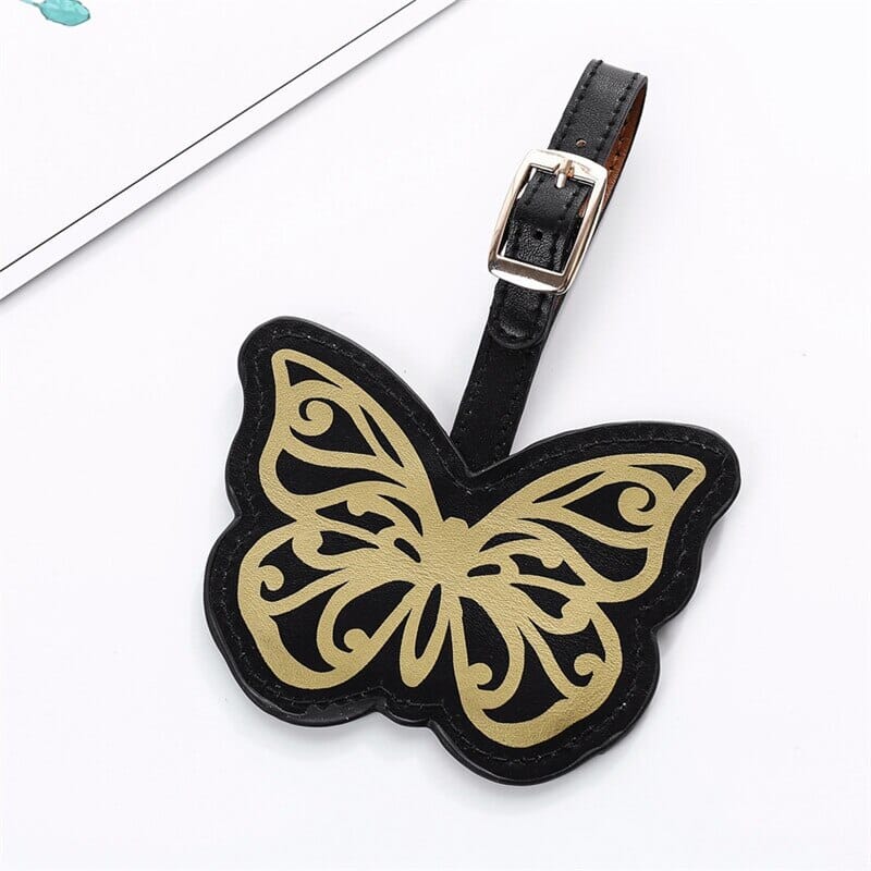 Étiquette Bagage Papillon noire avec motif doré, idéale pour vos voyages en avion ou train.