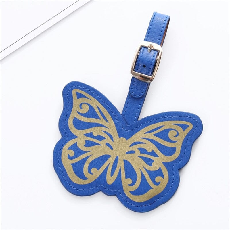 Étiquette Bagage Papillon en bleu, idéale pour voyager avec style. Attachez-la facilement à vos bagages.